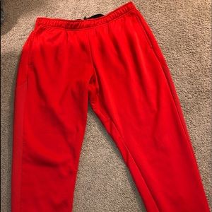 Bright red Nike sweatpants with drawstring and pockets